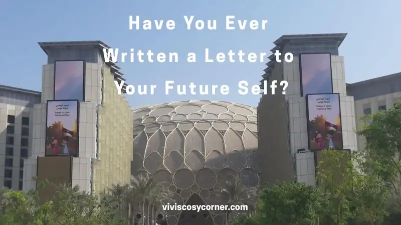 Promotional image with bold white text asking, 'Have You Ever Written a Letter to Your Future Self?' over a glass-domed building and banners; site name at bottom.