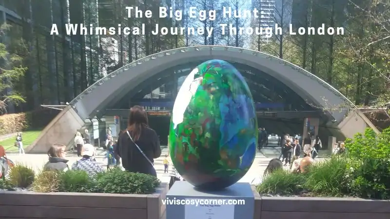 Public park scene with a large colorful glass egg sculpture titled 'The Big Egg Hunt: A Whimsical Journey Through London' in front of a curved pavilion, people nearby.