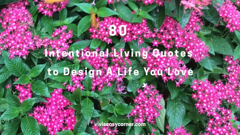 Pink clusters of flowers fill the frame with bold white text reading: '80 Intentional Living Quotes to Design A Life You Love', with a small 'vivisocorner.com' credit at the bottom.