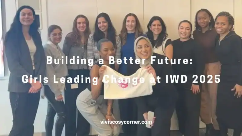 Group of diverse women smiling and posing together indoors; white overlay reads “Building a Better Future: Girls Leading Change at IWD 2025.”