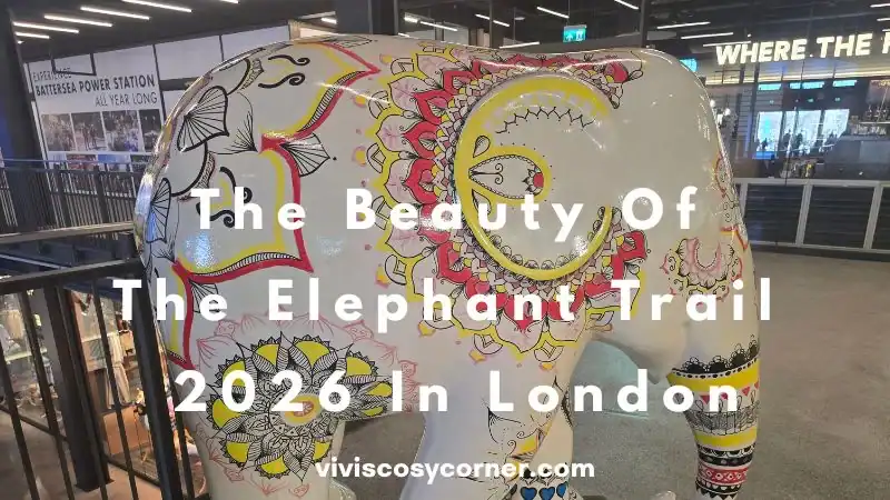 Colorfully painted elephant sculpture in a gallery with the title 'The Beauty Of The Elephant Trail 2026 In London' overlaid on the image.