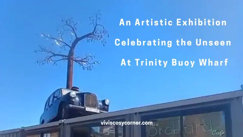 Poster advertising an art exhibition at Trinity Buoy Wharf titled 'An Artistic Exhibition Celebrating the Unseen,' with a vintage car perched on a building roof beneath a blue sky; includes viviscoscorner.com.
