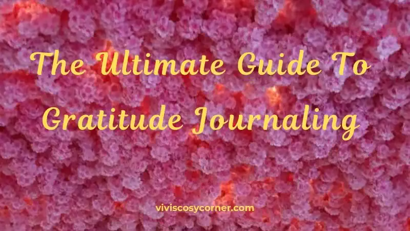 Cover image with pink flower background and yellow cursive title: 'The Ultimate Guide To Gratitude Journaling'; site text at the bottom